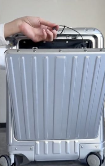 Silver front-opening suitcase shown in the WhatAFind product video.